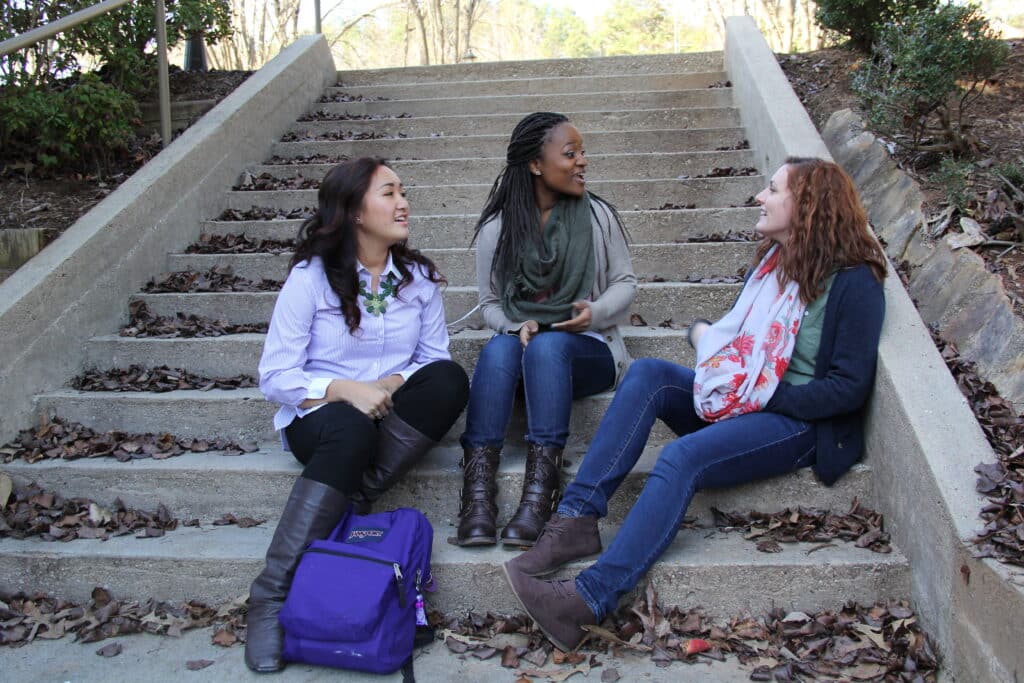 Toccoa Falls College students talking on stairs