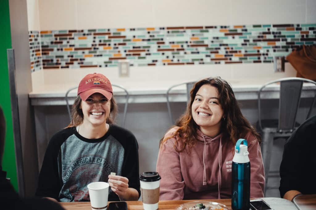 Two Toccoa Falls College students smile in a cafeteria